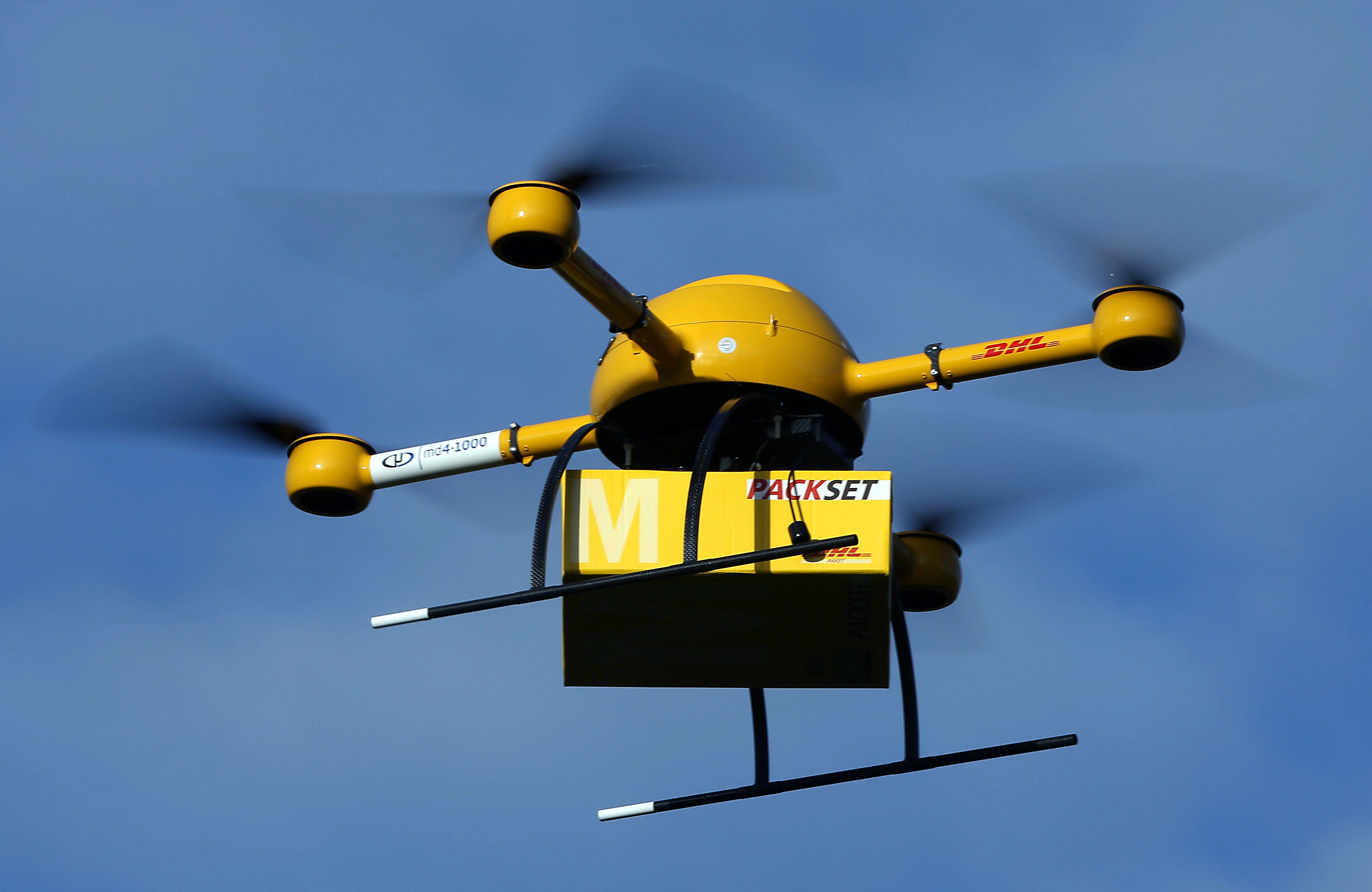 An unmanned aerial vehicle (UAV) carries a parcel in Bonn, Germany, 09 December 2013. Deutsche Post DHL has for the first time tested parcel deliveries with a drone. Photo by: Oliver Berg/picture-alliance/dpa/AP Images